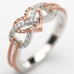 ladies size 5 ring, sterling and rose gold with nat. white sapphires